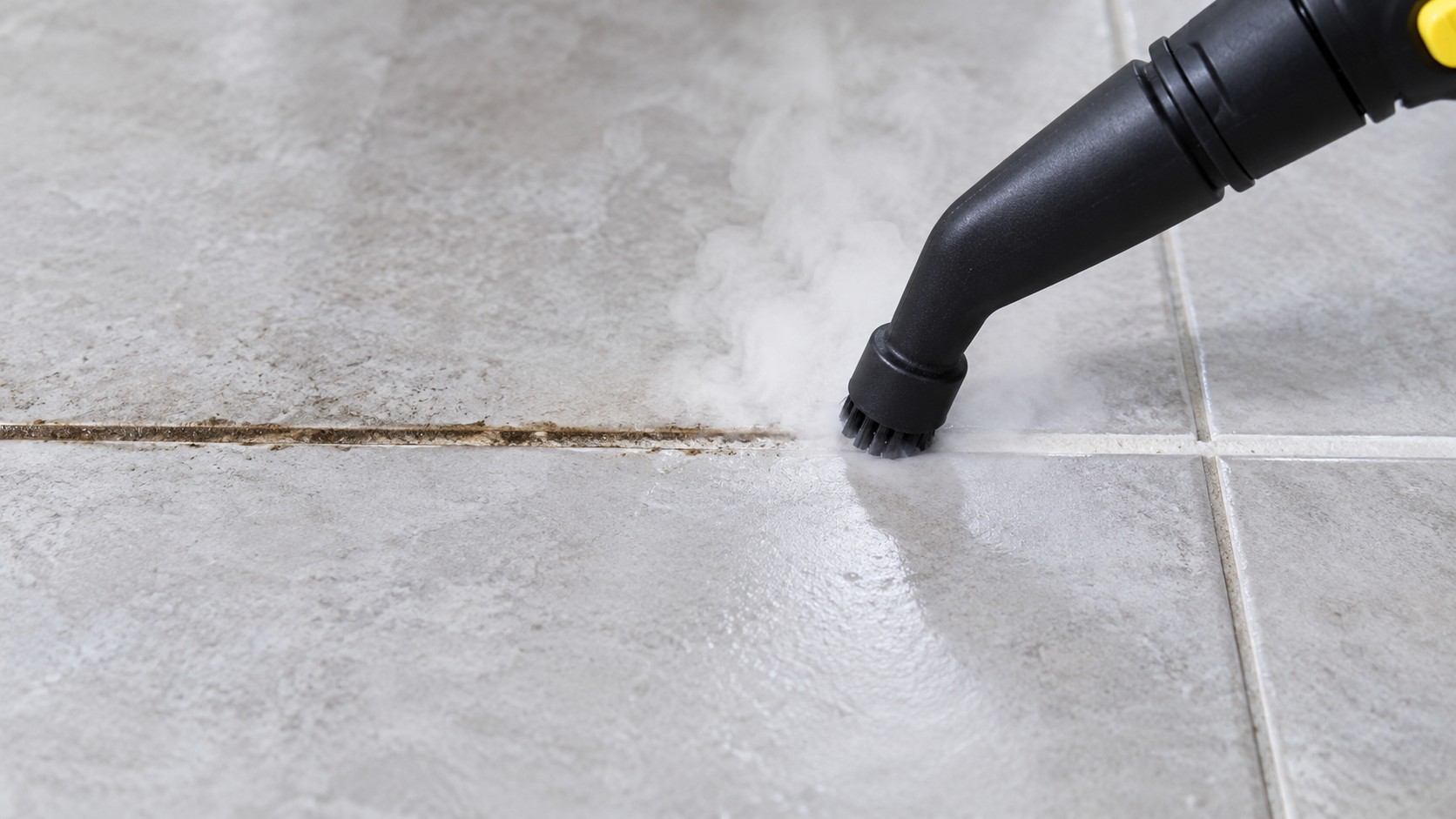 How to Remove Black Mold Stains from Grout Without Bleach 6 Steam cleaner nozzle passing slowly along a tile grout line